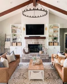 a living room filled with furniture and a flat screen tv mounted on the wall above a fireplace