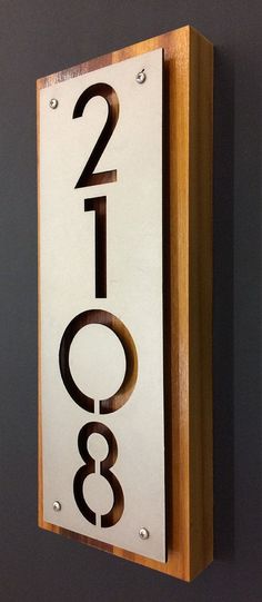 a metal and wood sign with numbers on it