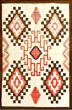 an old navajo rug with red, brown and white designs on the front end is shown