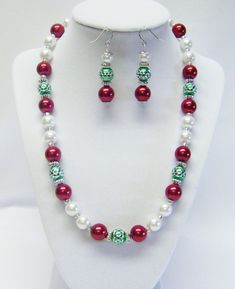 "Holiday Colors- Red/White Glass Pearl w/Green/Silver Bead Necklace/Earrings Set  This necklace set is made with 10mm red and white glass pearls, green with silver acrylic beads and silver plated spacer beads strung on flexible beading wire. It is 19 ½\" in length and fastens with silver lobster clasp. It comes with earrings that hang from silver fish hook ear wires.  Necklace Length: 19 ½\" Earrings Length: 2\" (including ear wires) Closure: Silver Lobster Clasp @325" 2 Earrings, Silver Fish, Kids Bracelets, Silver Bead Necklace, Holiday Colors, Beading Wire, Bead Stringing, Silver Bead, Christmas Jewelry