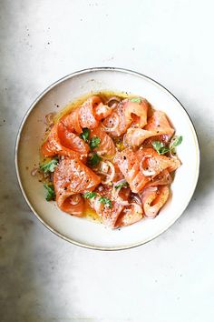 a white plate topped with pasta covered in sauce