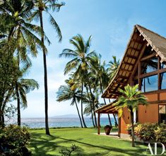 an ocean view from the front lawn of a tropical house