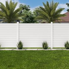 a white fence in front of some palm trees