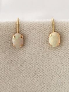 "Free Shipping on orders over $35.00 however if there is a return buyer to refund seller for the free shipping cost to seller. 14K Solid Fine Gold Opal Oval Cabochon Earrings White Base with Reds an Greens Play of Color Marked 14k - Test 14k Gemstone - Opal measure - 7.09mm or 0.28\" x 0.20\" or 5.08mm Genuine Opals earring screw back claspFree Shipping on orders over $35.00 however if there is a return buyer to refund seller for the free shipping cost to seller. Free Shipping on orders over $35 Green Play, Cabochon Earrings, Earrings White, Opal Earrings, Small Earrings, Gold Hoops, Oval Cabochon, Silver Hoops, Belly Button Rings