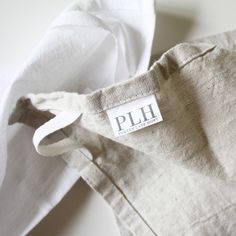 a white shirt with a label that says plh on the front and back side