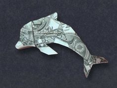 an origami fish made out of dollar bills