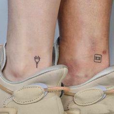 two people with tattoos on their legs and one has a small tattoo on the ankle