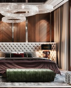 a large bed sitting under a chandelier in a bedroom