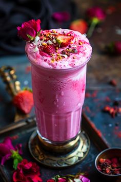 a pink drink with flowers on the table