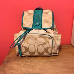 Never Used! Really Pretty Teal Color With Cream Coach Design. Drawstring Type Close With Magnetic Snap Button. Zipper Pocket On Front. Adjustable Straps. Casual Coach Backpack, Casual Coach Bags For School, Casual Coach Backpack For On-the-go, Casual Coach Backpack For Travel, Casual Coach Backpack With Adjustable Strap, Coach Backpack, Teal Colors, Coach Bags, Zipper Pocket