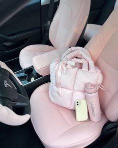 the interior of a car with pink leather seats and steering wheel covers, including a cup holder