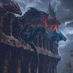 two dragon statues on top of a building in the rain