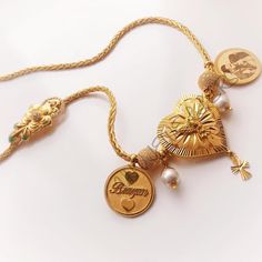 a gold necklace with two charms on it