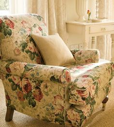 a living room with a floral chair and table