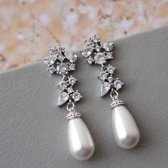 Vintage style  earrings  Colour: rhodium/silver tone/clear  /lt.ivory  Stud earrings. Length approx : 4 cm All components- rhodium over brass components, zircon crystals ,faux  white/light ivory pearls.   Great for you or for your bridesmaids. Other earrings: https://www.etsy.com/uk/shop/DonataleFlowers4You?ref=hdr_shop_menu&section_id=19125584 ❤Back to store DonataleFlowers4You: https://www.etsy.com/uk/shop/DonataleFlowers4You?ref=shopsection_shophome_leftnav In all my shop listing I have made every effort to ensure that the images match the item as closely as possible! However, colours do vary on different monitors. Some images have been enlarged to allow for details to be shown. Please read the descriptions for details on actual size of each item. Photography by STPhotography. ※Thank yo Bridesmaid Hair Comb, Silver Chandelier Earrings, Pearl Earrings Wedding, Vintage Style Earrings, Ivory Pearl, Silver Art, Art Deco Earrings, Cluster Earrings, Wedding Jewelry Earrings