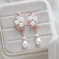 These lovely earrings I created with Premium cubic zirconia stones flower components and faux pearls.  Crystal pearl dangle on bottom.   Beautiful rose gold finish.  Earrings dangle 2-3/8 inch and are 3/4 inch at their widest. Gorgeous sparkle ! Pearls are diamond white meant to match with white or ivory dresses. PLEASE ALLOW APPROX 5 BUSINESS DAYS FOR COMPLETION BEFORE SHIPPING. MATCHING HAIR COMB: https://www.etsy.com/listing/1275702693/rose-gold-hair-comb-with-pearls-bridal?click_key=cca84dcd Rose Gold Pearl Drop Flower Earrings, Rose Gold Flower Drop Earrings With Pearl, Rose Gold Flower Earrings With Pearl Drop For Wedding, Rose Gold Pearl Drop Flower Earrings For Wedding, Rose Gold Cubic Zirconia Dangle Pearl Earrings, Pearl Drop Earrings Bridal, Earrings Pearl Drop, Rose Gold Bridal Earrings, Wedding Earrings Drop