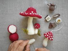 someone is making miniature mushrooms out of felt