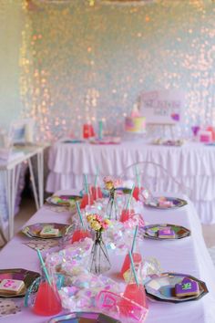 a table set up with plates, cups and napkins for a birthday party or baby shower