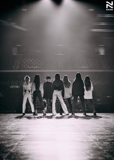 a group of young people standing on top of a stage in front of a crowd