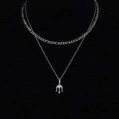 Hey there, meet your new go-to accessory: the Ferni Stainless Steel Trident Pendant & Figaro Chain Necklace Set. It rocks not one, but two chains – one long, featuring the powerful Trident pendant, and the other shorter with a cool Figaro chain design. It's sharp, it's spunky, and it's all about making a statement. This set is packed with meaning, symbolizing self-control and wisdom. Get ready to feel like a hero every time you wear it. Specifications: When it comes to men's necklaces, stainless Trident Pendant, Diamante Bracelet, Men's Necklaces, Leather Choker Necklace, Figaro Chain Necklace, Figaro Chains, Pearl Choker Necklace, Figaro Chain, Natural Stone Bracelets