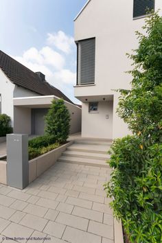 a house that has some plants in front of it