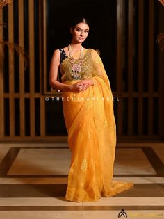 "Yellow Chikankari Saree in Organza Fabric for Women Hand Embroidered Lucknowi Chikan Sari for Wedding Bollywood Wear Sari Blouse for Her > Saree Fabric: Organza > Saree Length: 5.9 Mtrs. > Blouse Fabric: Organza > Blouse Length: 0.80 Mtrs. > Occasions: Party Wear, Wedding Wear, Festive Wear > Price Includes: Saree with an Un-stitched Blouse Thechikanlabel designer studio presents \"Yellow Chikankari Saree in Organza Fabric for Women\" Floral motifs with 'intricate embroidery' are delicately placed on this handmade Chikankari Saree, this perky hand embroidered Lucknowi Chikan Sari is a reminiscent of blooming springs and the serenity that surrounds it. Your skin will surely fall in love with soft fabric that will keep you comfortable all day long and make yourself happier this season by ch