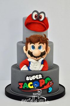 a close up of a cake with a cartoon character on the top and bottom tier