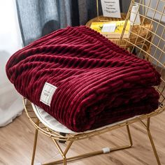 a red blanket sitting on top of a chair