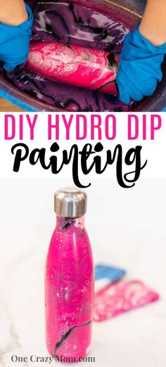 a bottle filled with pink liquid sitting on top of a table next to a child's hand