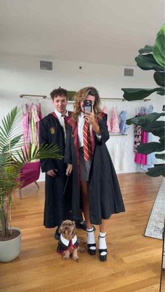 a man and woman taking a selfie in front of a mirror with a dog