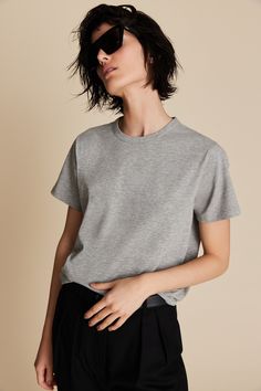 Classic cut, slightly oversized tee with crew neck. Center back seam detail. Fits true to size, take your normal size. Model is wearing an XS. 90% Peruvian cotton. 10% polyester. Gentle machine wash cold, inside out, with like colors. Lay flat or tumble dry on delicate cycle. Classic Wardrobe, Grey Tee, Oversized Tee, Tee Shop, Heathers, Heather Grey, Inside Out, Organic Cotton, Relaxed Fit