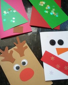 four different colored paper christmas cards with reindeer faces and snowflakes on the sides