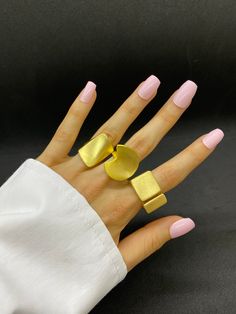 Discover our exquisite collection of unique gold statement rings, each crafted with exceptional attention to detail. Choose from a variety of designs including chunky, textured, and chain-inspired styles, perfect for adding a touch of elegance and boldness to any outfit. Each ring is sold separately, allowing you to select the exact style that suits your personal taste. Elevate your jewelry collection with these stunning pieces, ideal for both special occasions and everyday wear. Features: *Indi Modern Gold-tone Jewelry With Metal Ring, Modern Gold-tone Ring, Modern Gold-tone Open Ring Jewelry, Modern Chunky Yellow Gold Jewelry, Modern Open Ring Metal Jewelry, Modern Metal Open Ring Jewelry, Yellow Gold Metal Jewelry, Modern Gold Jewelry With Unique Variations, Trendy Gold Metal Rings