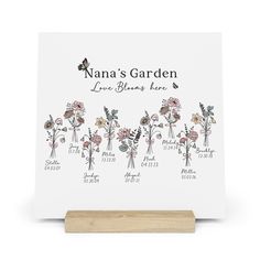 a wooden plaque with flowers on it that says nanna's garden, love blooms love