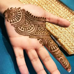 the hand is decorated with henna designs on it