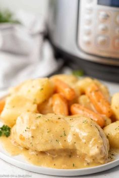 a white plate topped with potatoes covered in gravy next to an instant pressure cooker