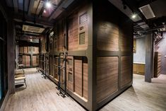 the inside of a building with wooden walls and chairs on each side of the room