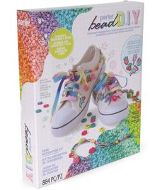 a pair of white shoes sitting on top of a box filled with colorful beads and beads