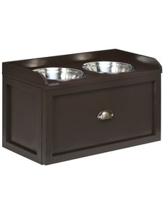 two bowls on top of a wooden box with metal lids and handles in the shape of a dog's food bowl