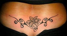 a woman's stomach with a flower tattoo on it