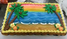 a decorated cake with palm trees on the beach