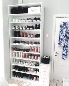 a white shoe rack filled with lots of shoes