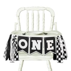 a black and white chair with a one banner on it's back, sitting in front of a white background