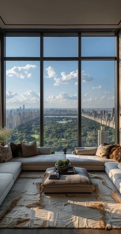 a living room filled with lots of furniture and large windows overlooking the cityscape