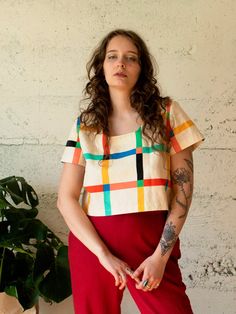 Bright plaid crop top featuring a square neckline, short sleeves, loose fit, and mid-length. Its loose fit makes it ideal for layering and wear year-round, and its bold colors make it a go-to statement piece. ✨ ✦ Made of 100% Cotton linen. ✦ Printed with high-quality eco-friendly ink. ✦ Hand sewn in Portland, OR. 📌 Please Note: These fabrics are custom-printed in small batches. Every batch of fabric is slightly different. Due to the unique printing process, please expect small character marks s Accessorize Bags, Plaid Crop Top, Hand Printed Fabric, Book Clothes, Hair Fragrance, Short Jacket, Short Jumpsuit, Winter Accessories, Men's Grooming