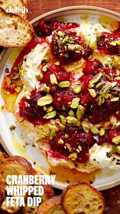 a white plate topped with bread and cranberry sauce next to sliced almonds