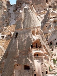 the rock houses are built into the side of the mountain