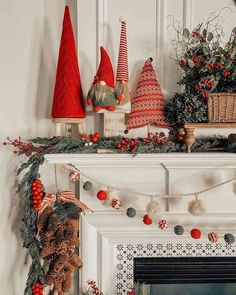 a fireplace mantel decorated with christmas decorations