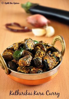 a bowl filled with cooked eggplant on top of a wooden table