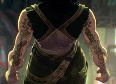 a woman with tattoos on her arms and back